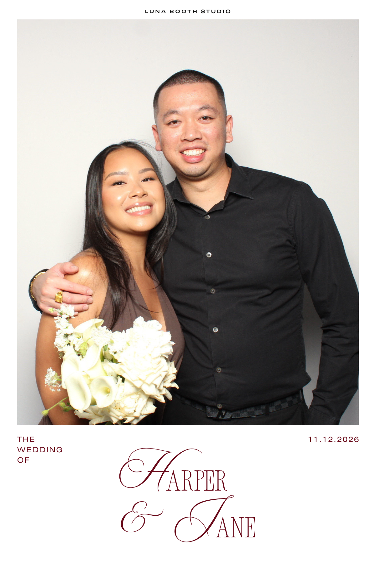 A smiling woman holding a bouquet of white flowers. She is standing next to a man who has his arm around her. Both are dressed formally. The background is plain white. The top of the image says 'LUNA BOOTH STUDIO.' The bottom of the image has text with the names Harper and Jane and a date, 11.12.2026, indicating a wedding celebration.