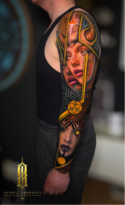 Detailed sleeve tattoo featuring a woman with closed eyes, horns, and abstract patterns in bold colors on a man's arm. Daniel Armitage, Calgary Alberta, Surrealist Tattoo Artist, YYC