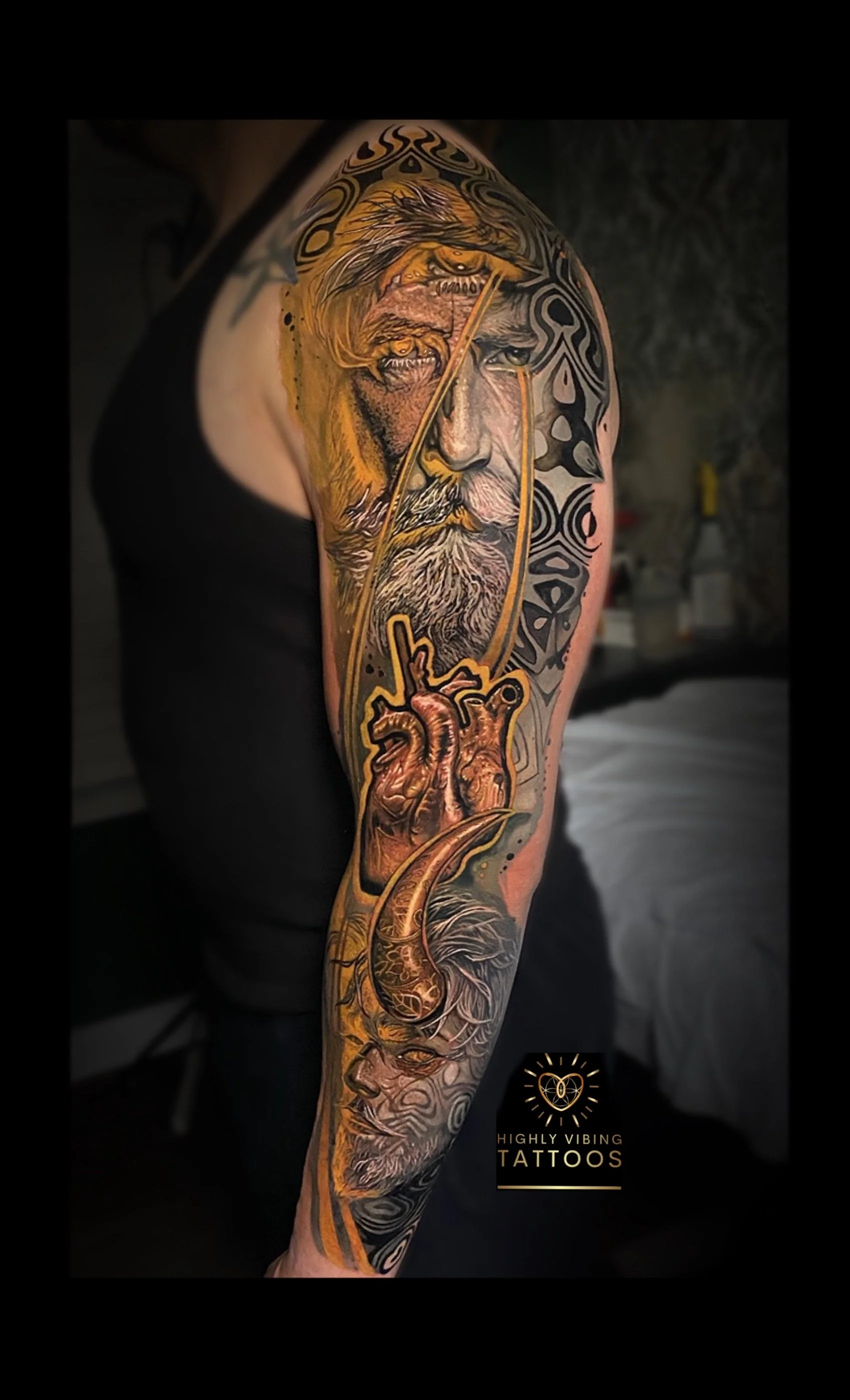 Colorful tattoo sleeve featuring a lion, a human face, a heart, and intricate black tribal designs. Daniel Armitage, Calgary Alberta, Surrealist Tattoo Artist, YYC