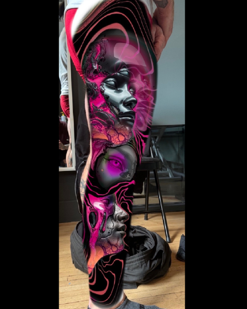 Daniel Armitage, Calgary Alberta, Surrealist Tattoo Artist, YYC Side view of a person's leg with a detailed tattoo sleeve featuring artistic black and gray faces with vibrant pink and purple abstract and swirling designs.