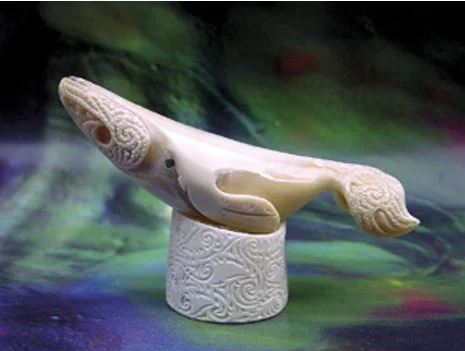 Sperm whale tooth carved into a whale