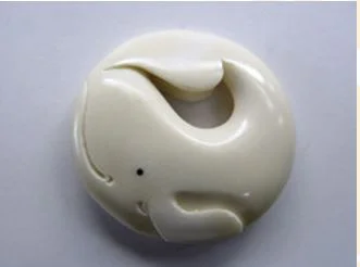 Two whale carvings derived from a yin–yang design. The incorporation of traditional features on the face, with the flippers depicted as hands, gives a more traditional appearance