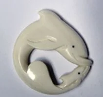 Three tohor ā carvings derived from a yin–yang design