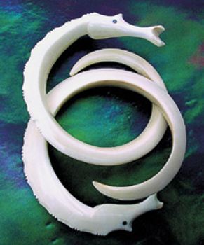 A pair of sea horses carved from wart hog tusks