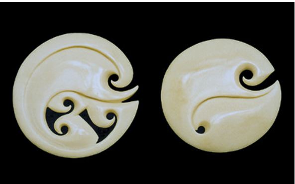 Two examples of a stylised koura design