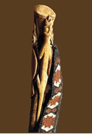 A weaving peg holding a muka belt made by Te Aue Davis