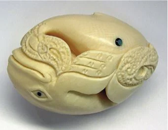 Whale-tooth carving with a reversed whale image