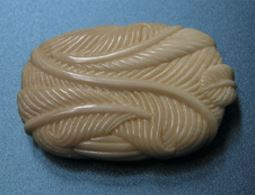 A feather bundle by Owen Mapp carved from mammoth ivory