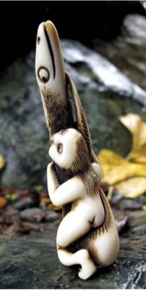 Aroha Hinapóuri, an antler carving by Doug Marsden depicting Hine te Repo and Tunaroa