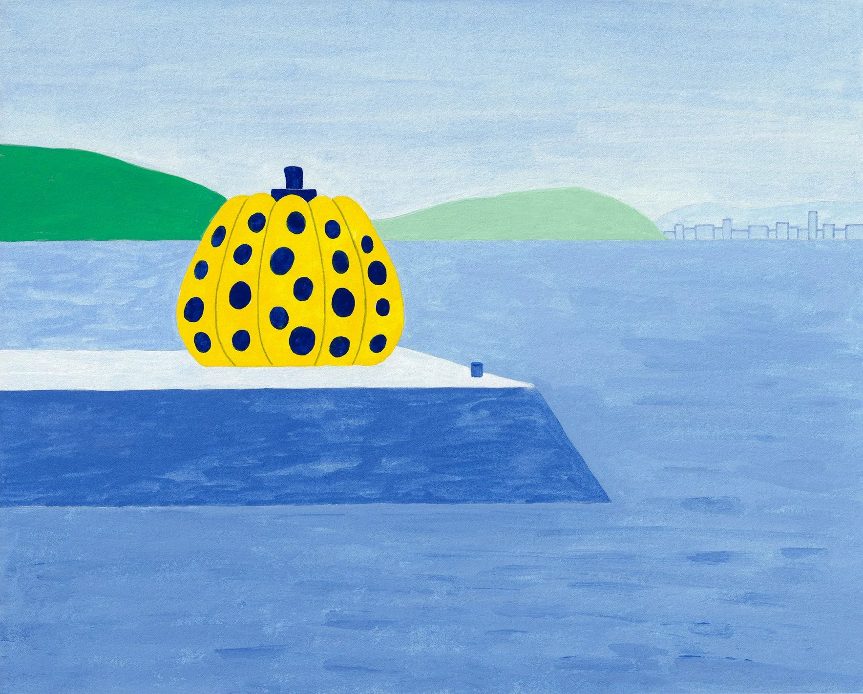 A view of Naoshima's Yellow Pumpkin on the pier set against a landscape with blue water, green hills, and a distant city skyline under a pale blue sky.