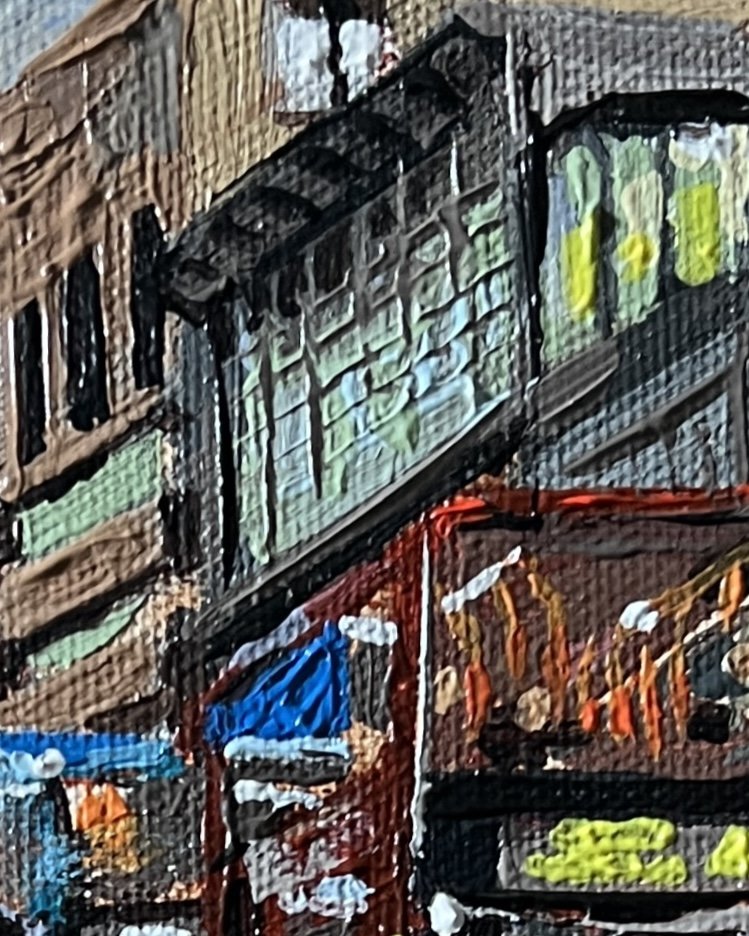 Close-up detail from Contemplating one in Spoons of Lancaster Police Station reflecting the silver blue of a dusk evening in its windows.