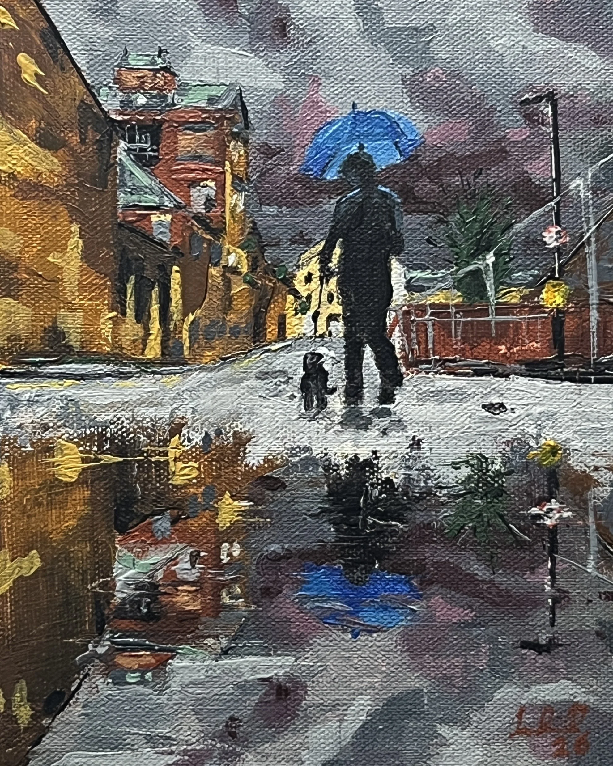 Oil painting showing a woman with blue umbrella walking a dog down Brewery Lane, Lancaster. Rain pouring, the skies are dark and moody. Sky, dog waker, abandoned buildings and harris fencing are all reflected a large puddle