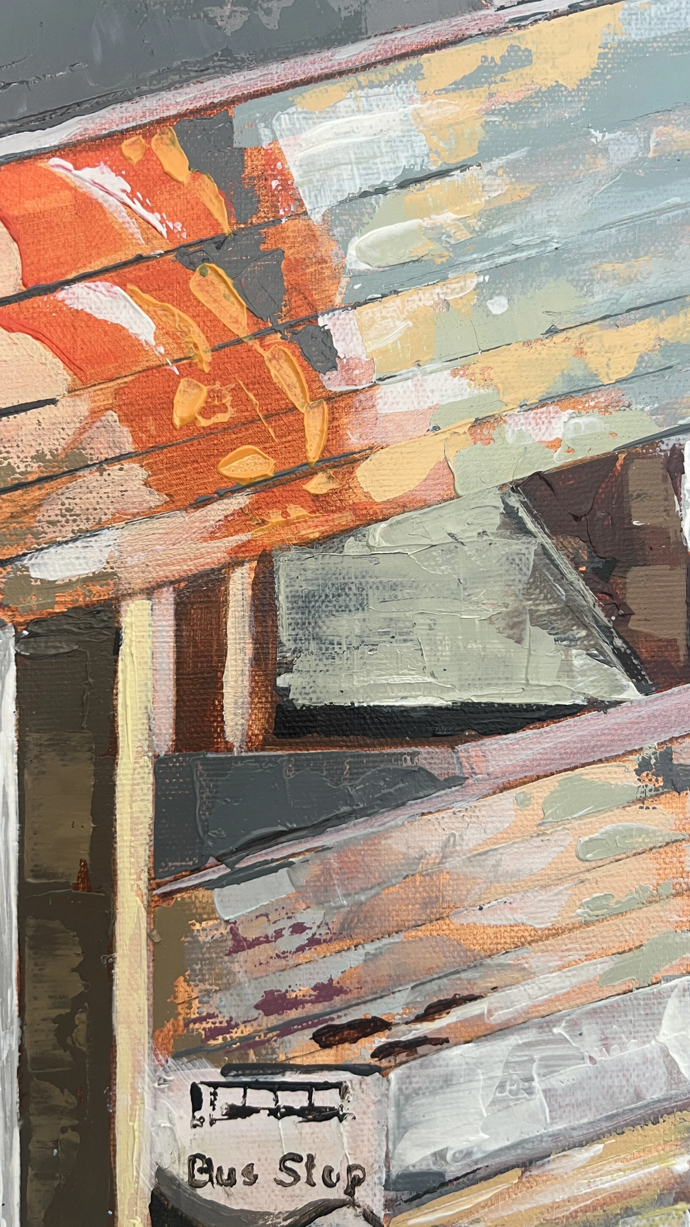 Close up oil detail of the canopies above the bus stop. Reflections of the couple passing by are caught, especially the males orange puffa. Blues of the sky and warm Lancaster stone are also shown in the reflection.
