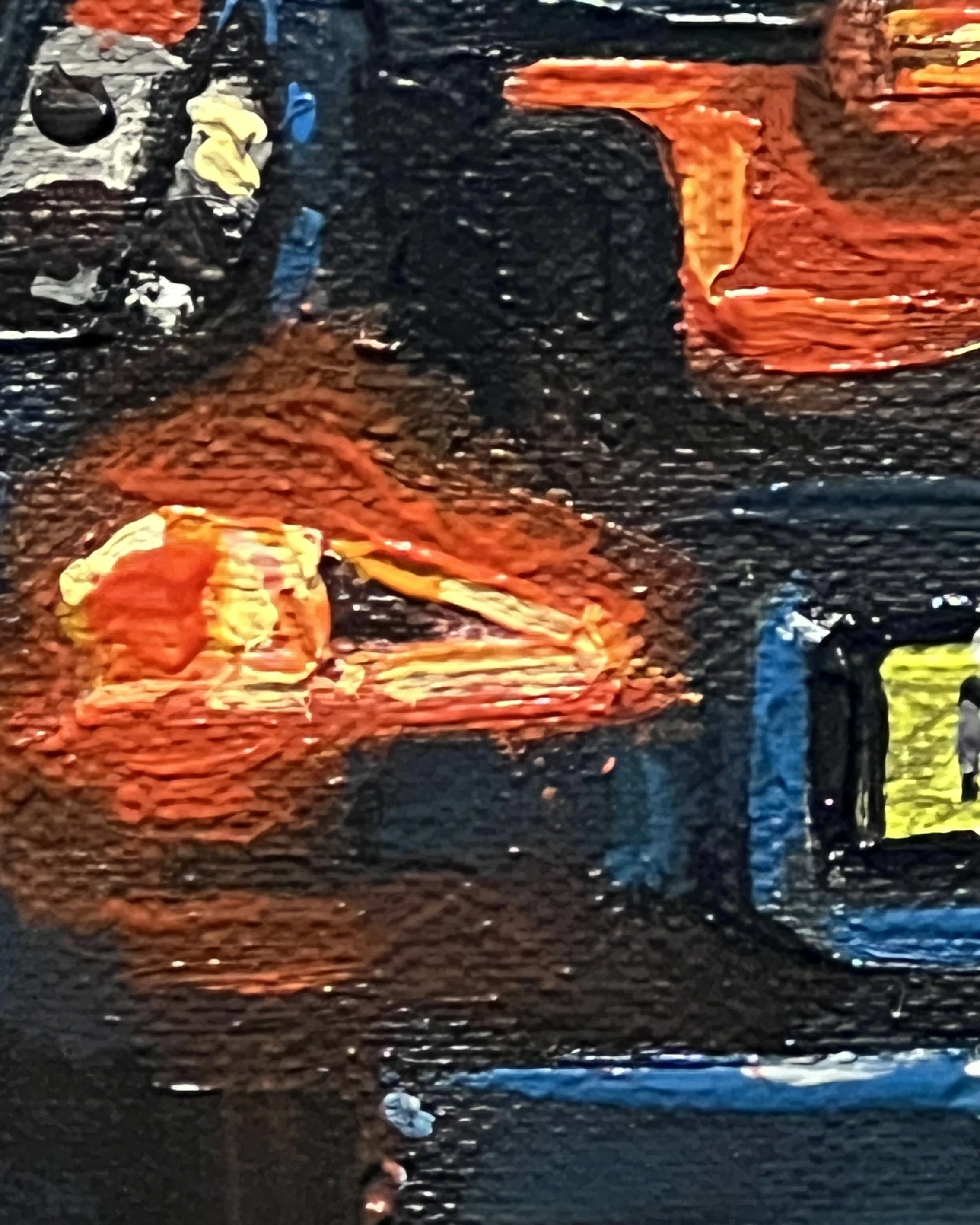 Close up detail of a rear red brake light from a taxi. The glowing lights highlights parts of the blue car.