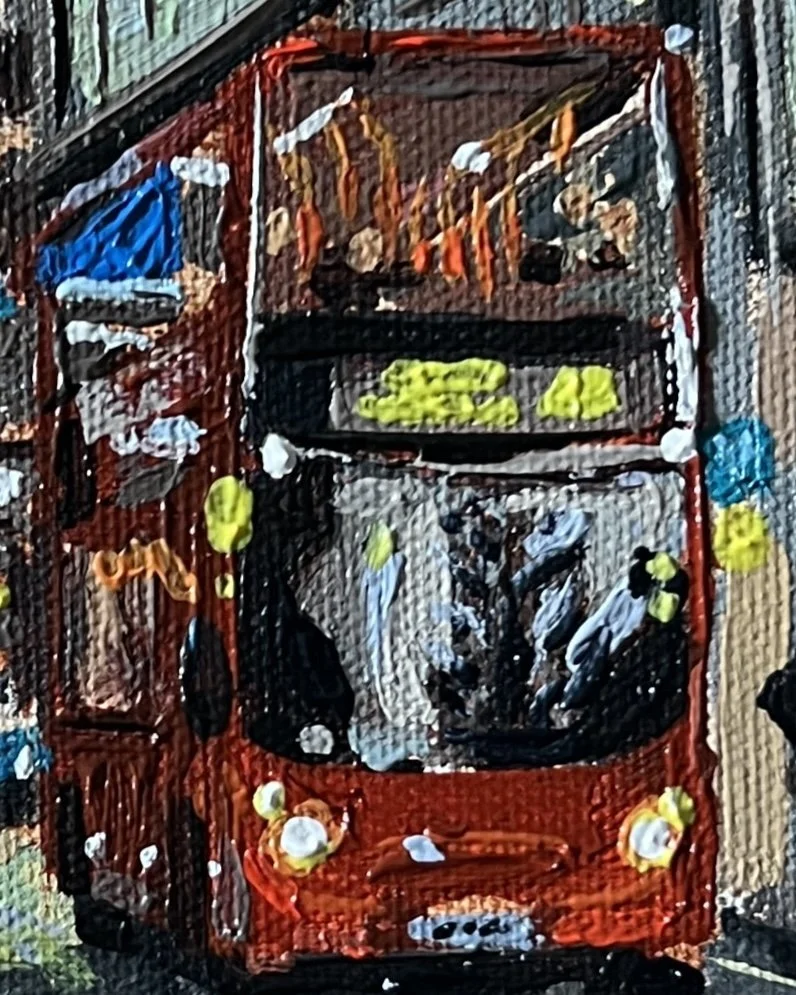 Close-up detail from Contemplating one in Spoons of a red double decker bus