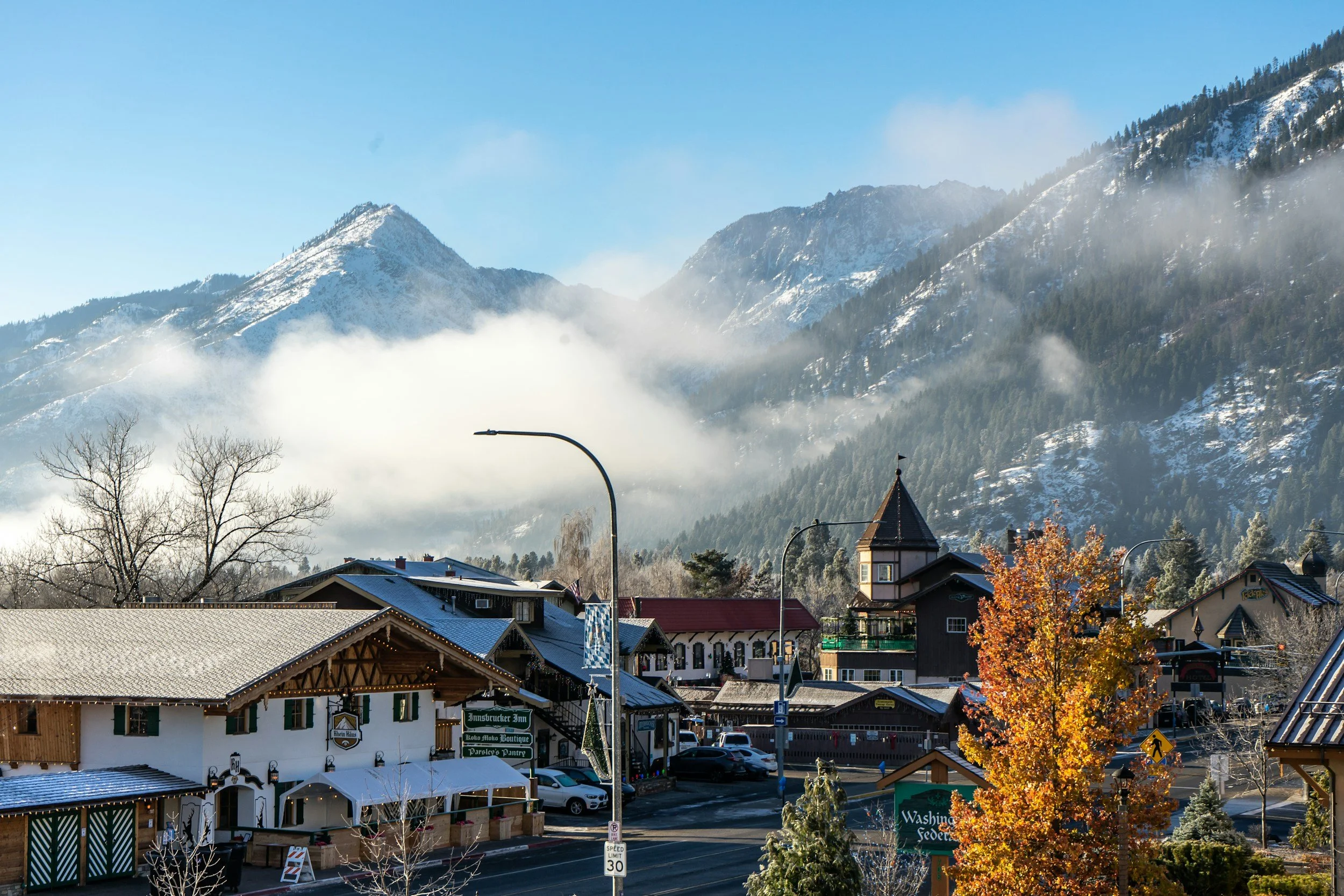Bavarian-style buildings beneath snow-dusted Cascade Mountains in Leavenworth, Washington.
