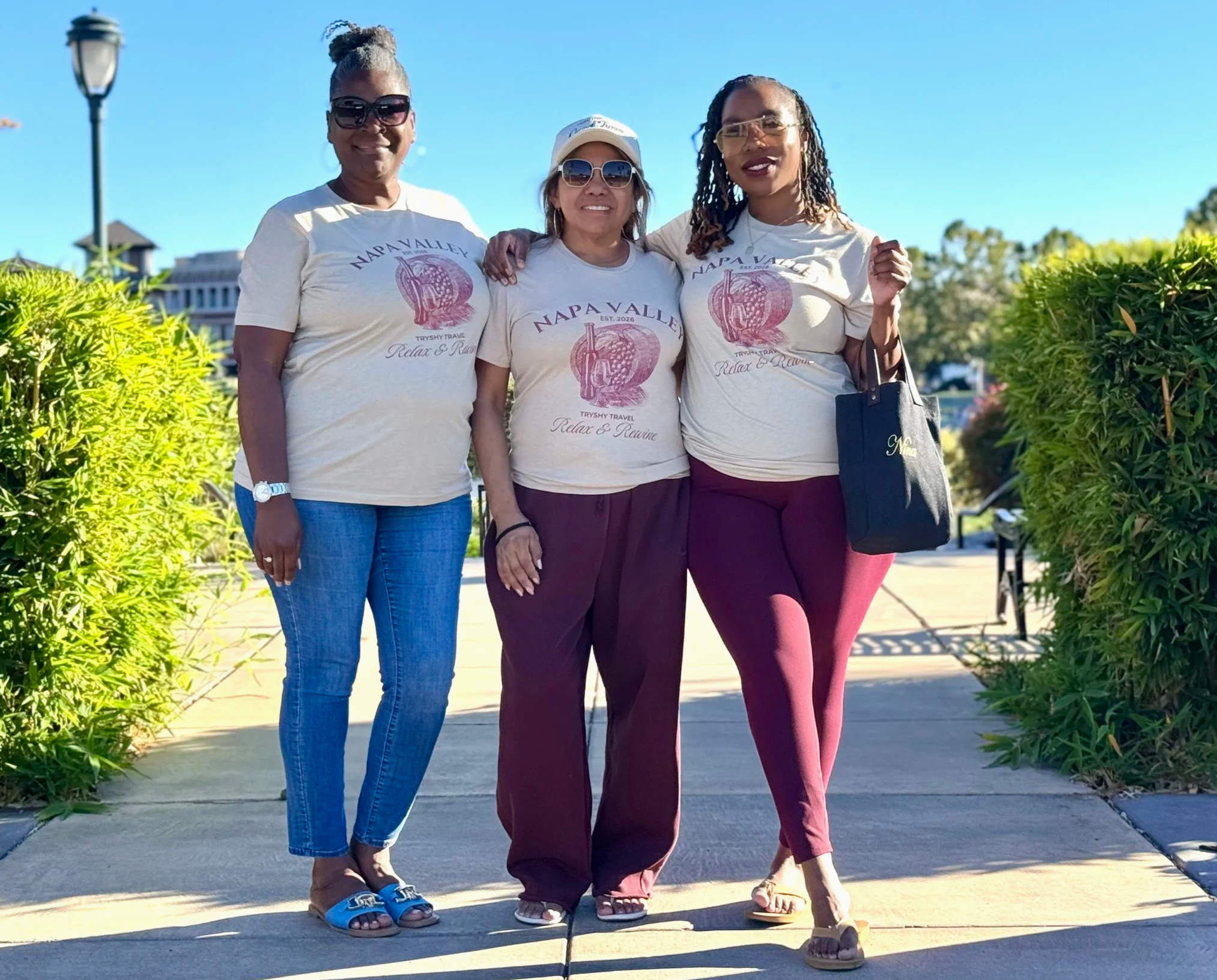 Three TryShy Travel guests wearing matching Relax & ReWine shirts during a hosted Napa Valley group trip.