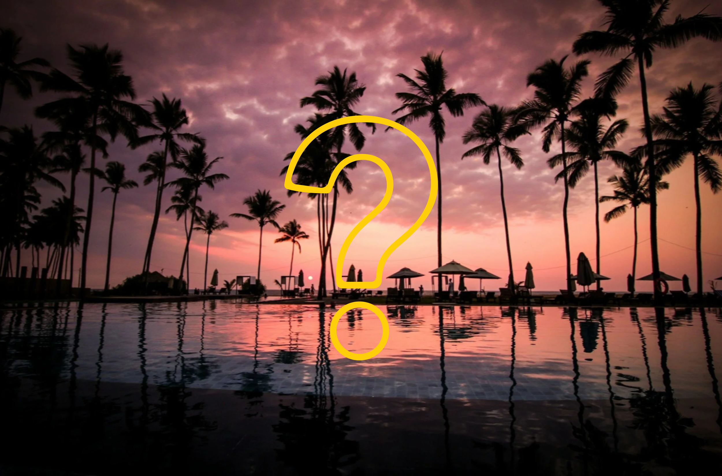 Tropical resort pool at sunset with silhouetted palm trees, lounge chairs, and cabanas reflected in calm water beneath a pink and purple sky.