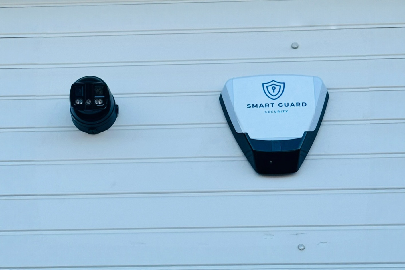 Security camera and a smart security device mounted on a wall.