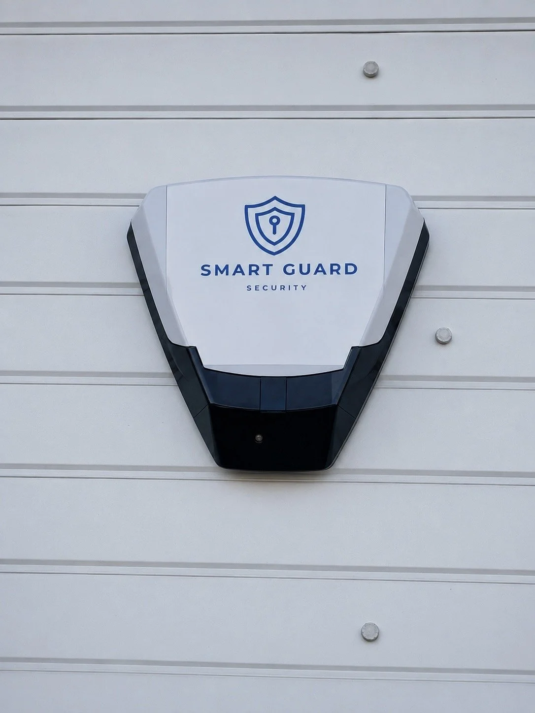 Security camera labeled 'Smart Guard' mounted on a white wall.