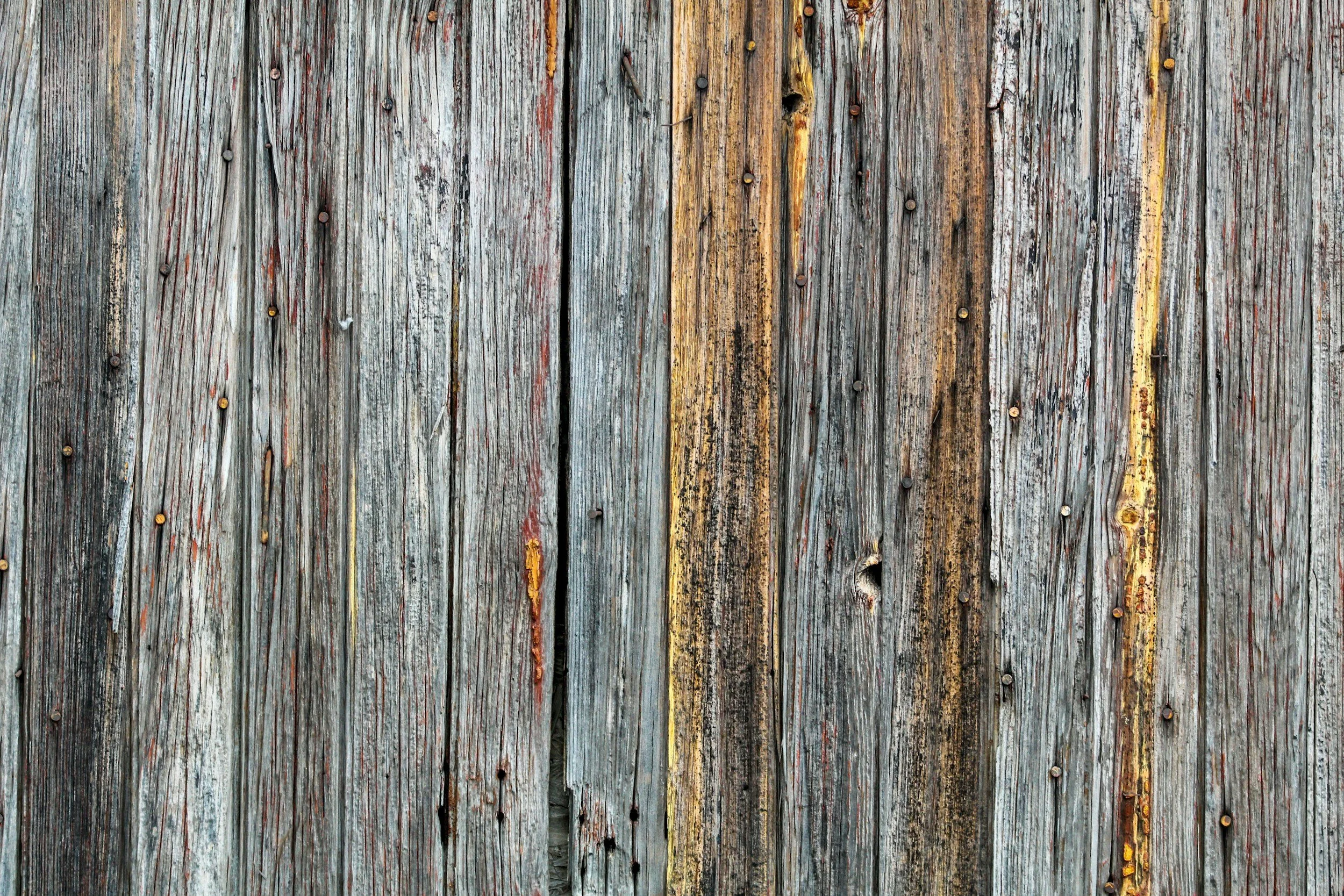 Close-up of old, weathered wooden planks with rusty nails.