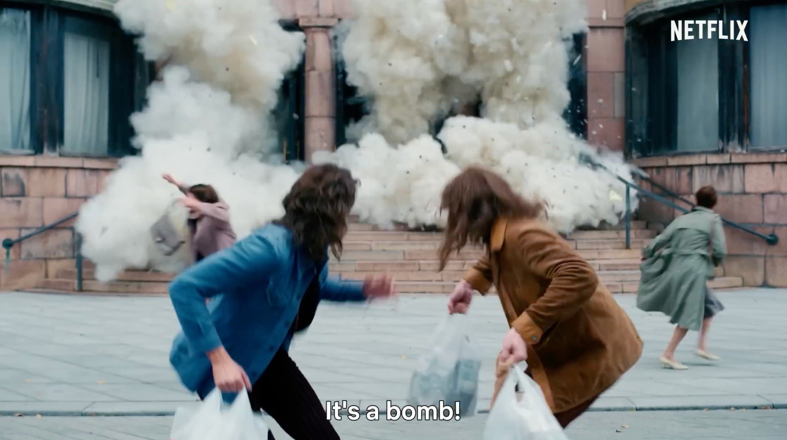 Actors running through white smoke on a street, scene shown in the Netflix CLARK making-of film by CTRL Pictures
