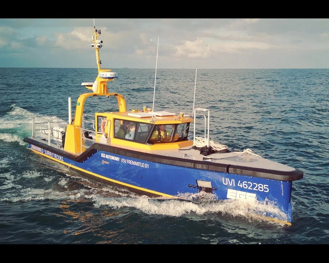 11.5m unmanned survey vessel underway, bow quarter view.