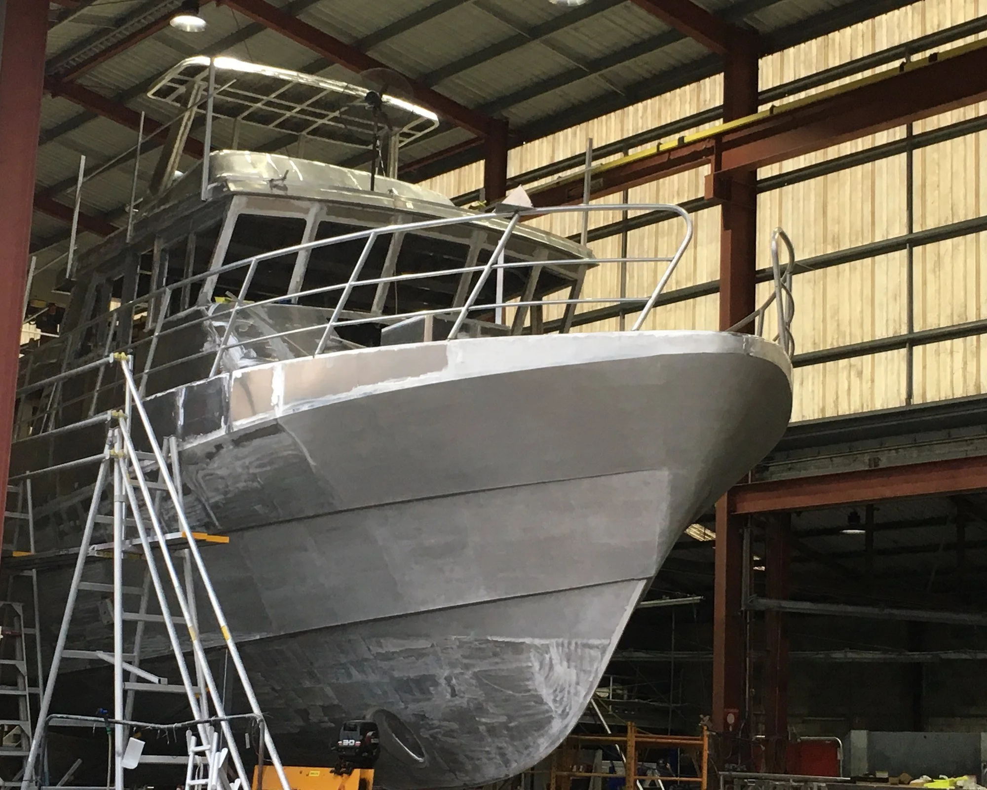 20m fisheries patrol vessel, bare aluminium hull under construction, bow view.
