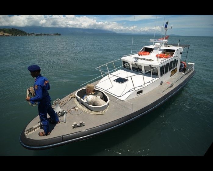 11.5m patrol boat with crew on the foredeck.