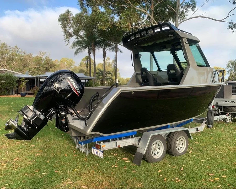 Sherwood Marine 600HT - 6m Hardtop aluminium boat kit - on the trailer, starboard quarter with the outboard tilted

