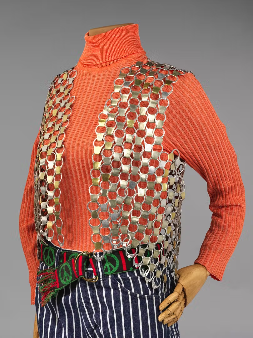 Pull-tab vest, turtleneck, bell-bottom jeans, and peace-symbol belt, 1970-75. In  Real Clothes, Real Lives: Two Hundred Years of What Women Wore , organized by the Smith College Historic Clothing Collection, presented at the New-York Historical Socie