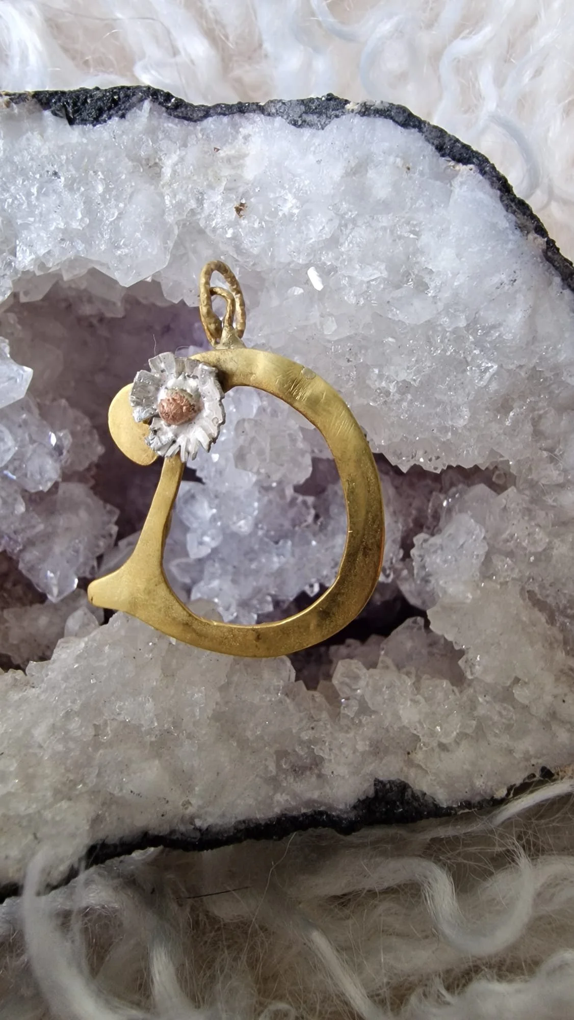 A custom font Scripted & Gilded 24ct Gold pendant adorned and juxtaposed with a simple Brutalist Daisy  - simple, elegant and timeless