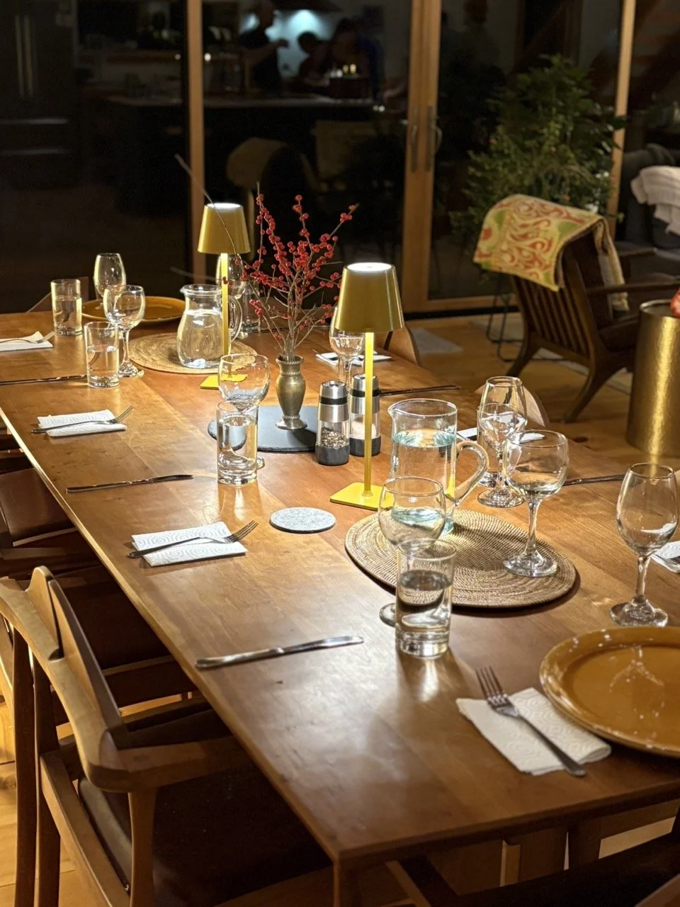 A warmly lit dining table at The Pond, set for a shared meal