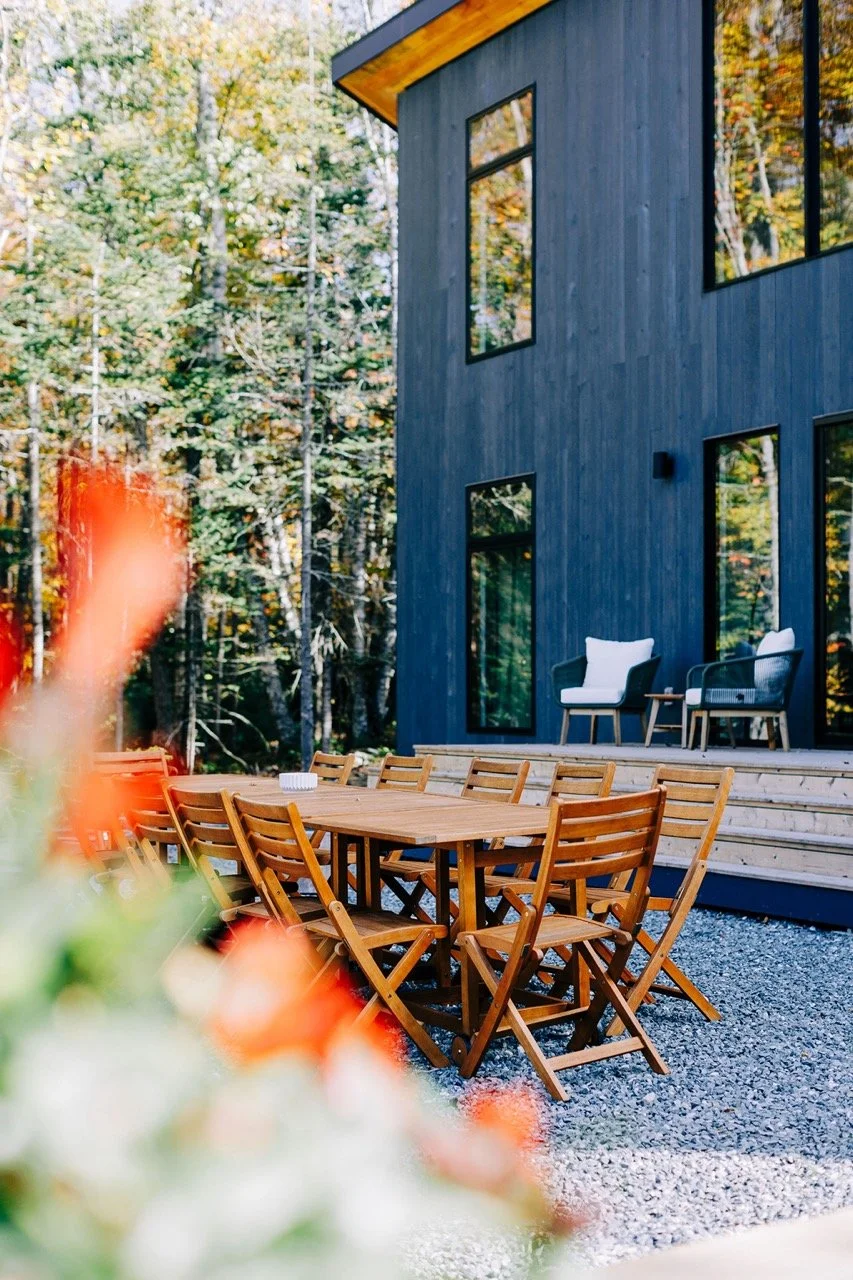 The blue guest house at The Pond, surrounded by trees
