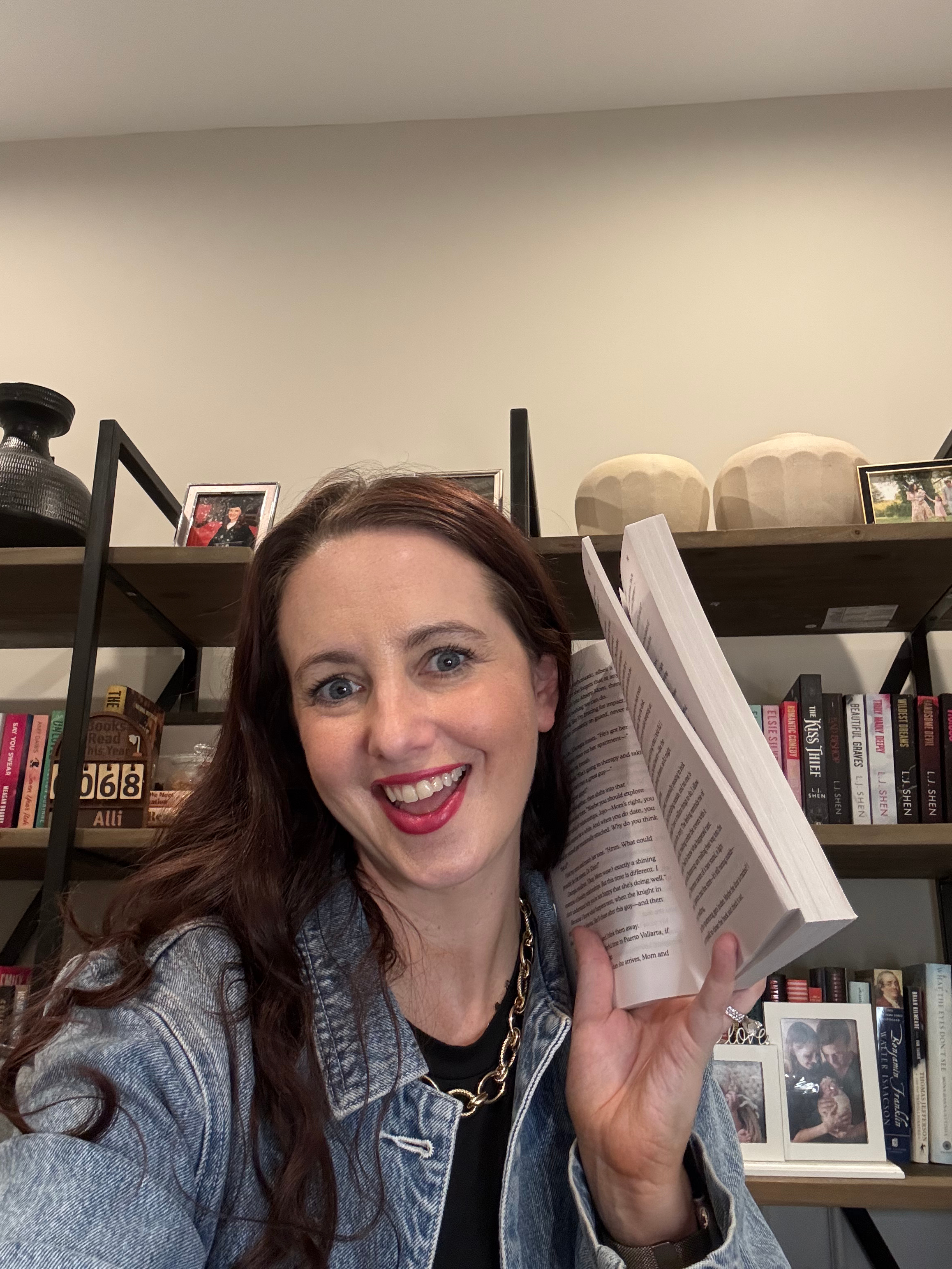 Alli Mowrey of Allireadstoomuch with a book