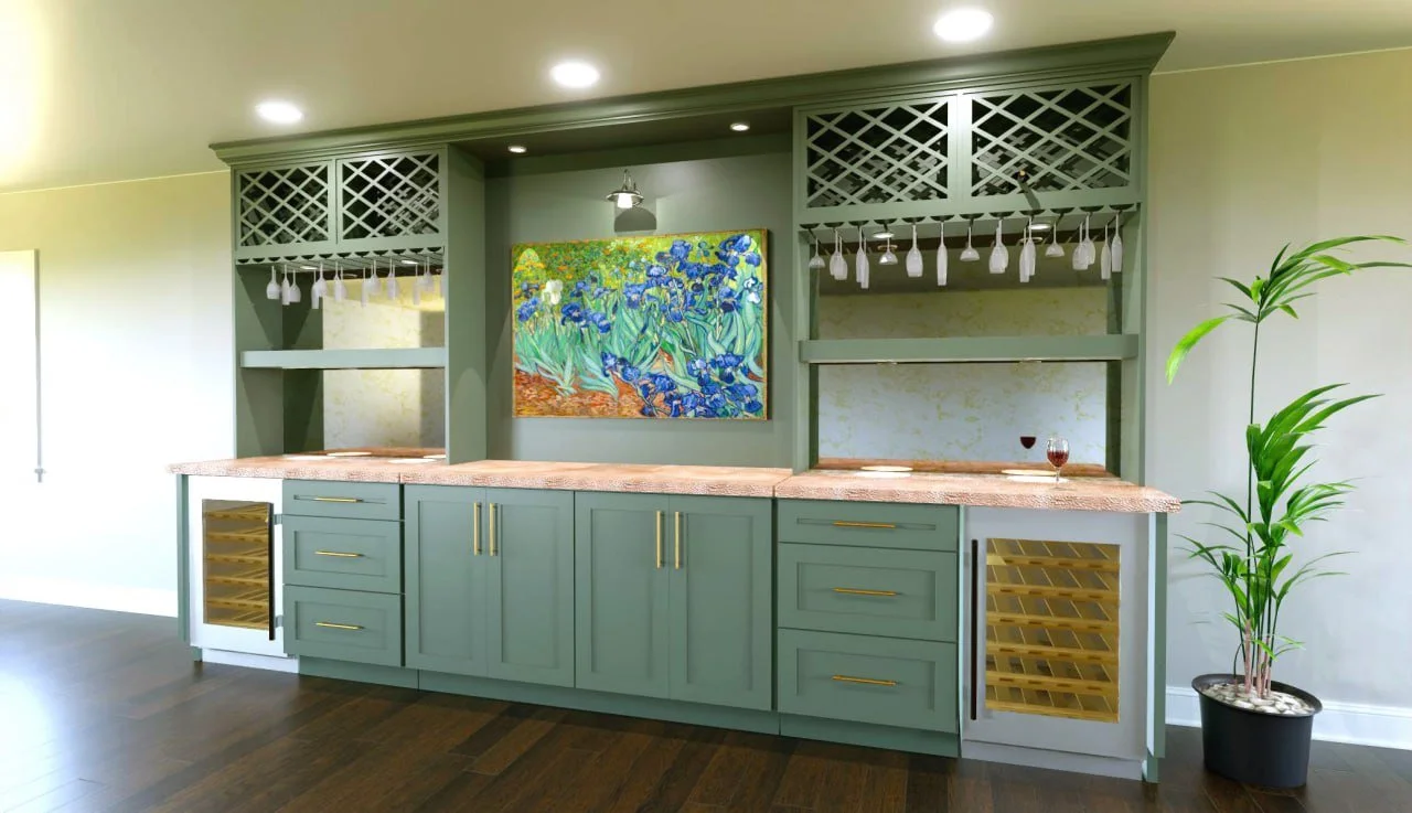 Green kitchen bar with built-in wine coolers, glass racks, and a colorful painting of irises on the wall, surrounded by a potted plant on the right and wooden flooring.