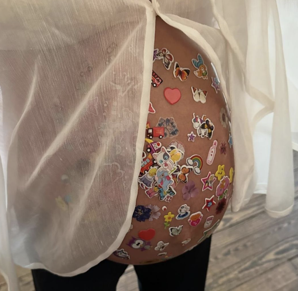 Baby bump with stickers on it 