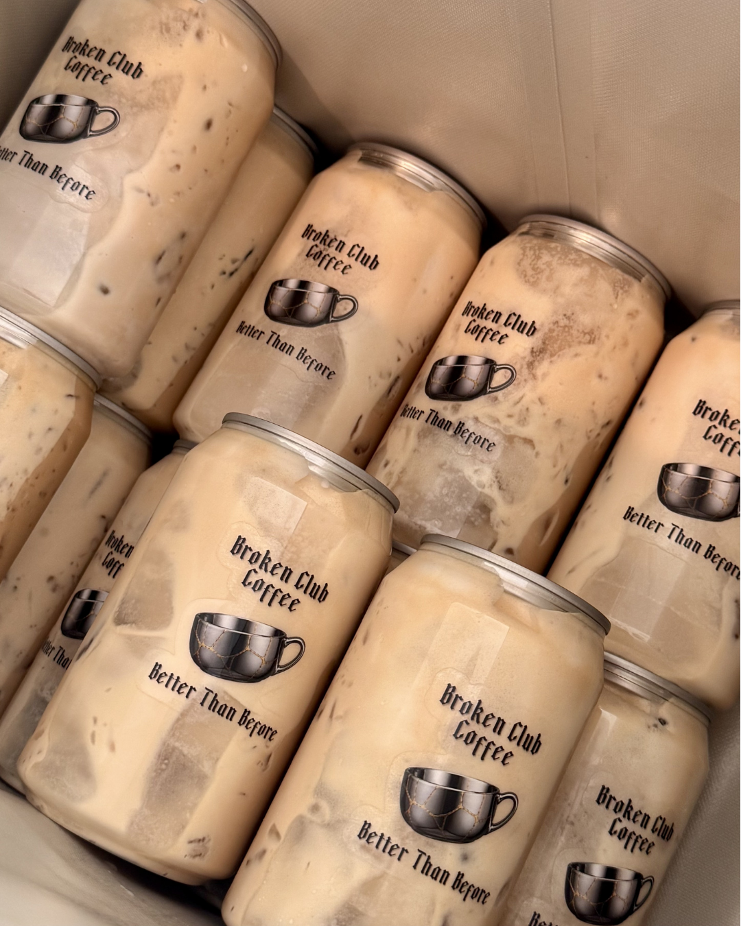 Several jars labeled 'Broken Club Coffee' with a mug logo and the slogan 'Better Than Before,'