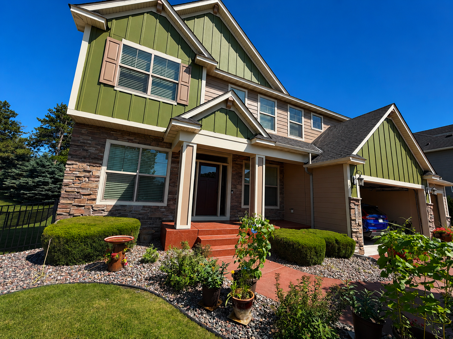 Exterior painting in Brooklyn Park, Minnesota. We painted just the front of the home here and turned it from a dark red to a green color. We used Hirshfield's Paintte