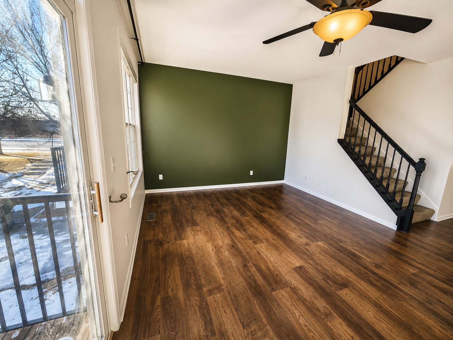 Shakopee, MN interior painting. We completed this main level repaint with a green accent wall in two days. The homeowner chose the color Greek Villa by Sherwin Williams.