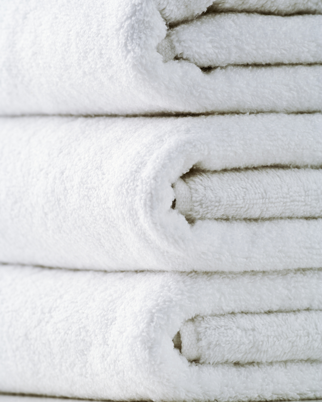 Stack of neatly folded white towels.