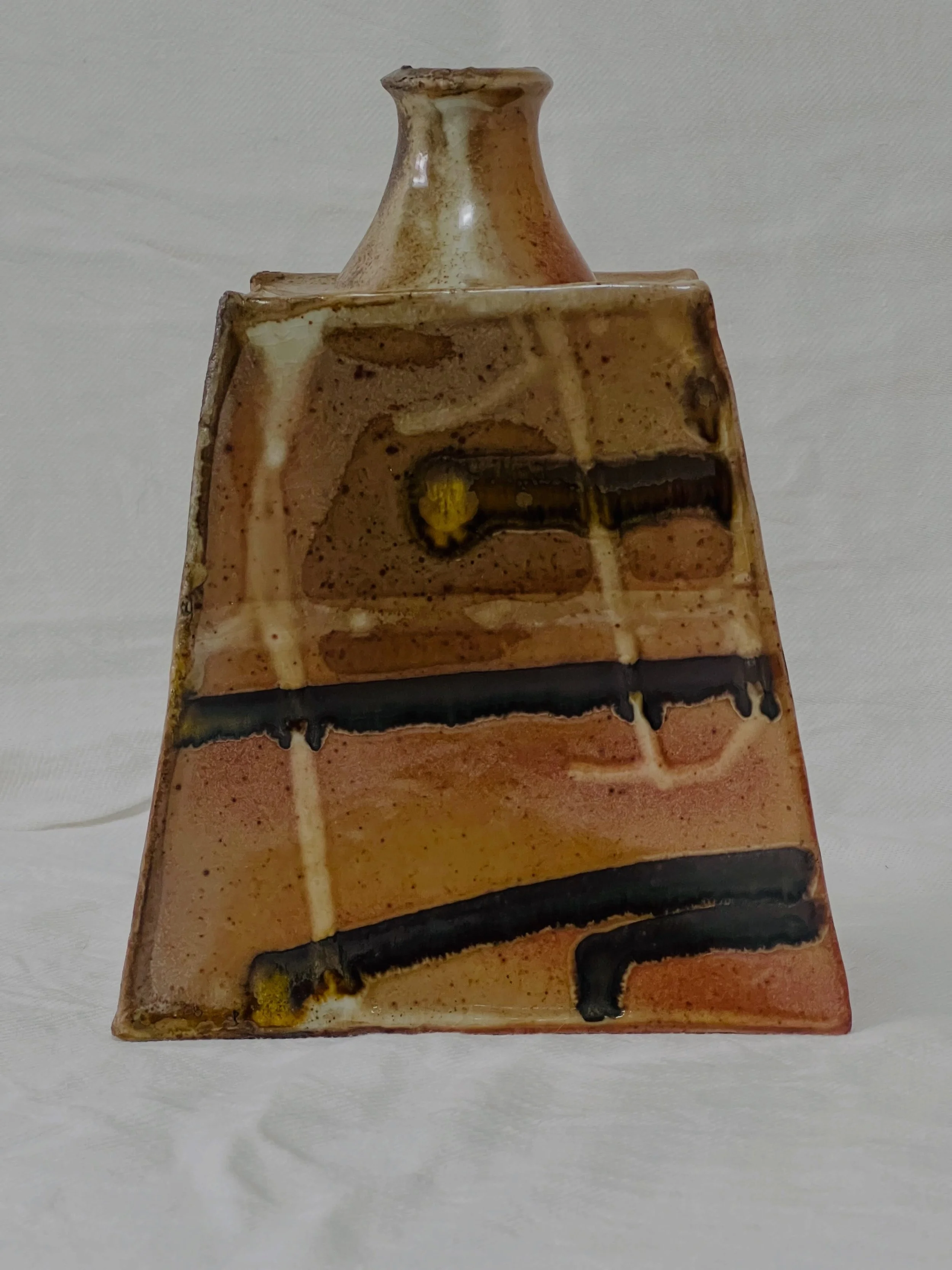 This is my new favourite. Randy Johnson Shino with Tenmoku stripes, fired in @nic.collins.75 kiln. It&rsquo;s like an 80s reversible jumper- a different pattern on the other side. The Shino is doing all the things I like; oranges and peaches, crackle