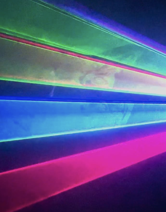 Colorful neon lights creating horizontal streaks in pink, blue, green, and purple.