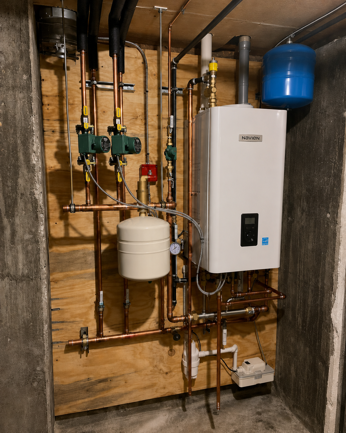 A domestic mechanical room with copper piping, a white Navien boiler, green circulation pumps, a beige expansion tank, a pressure gauge, and a blue expansion tank mounted on a wooden wall.