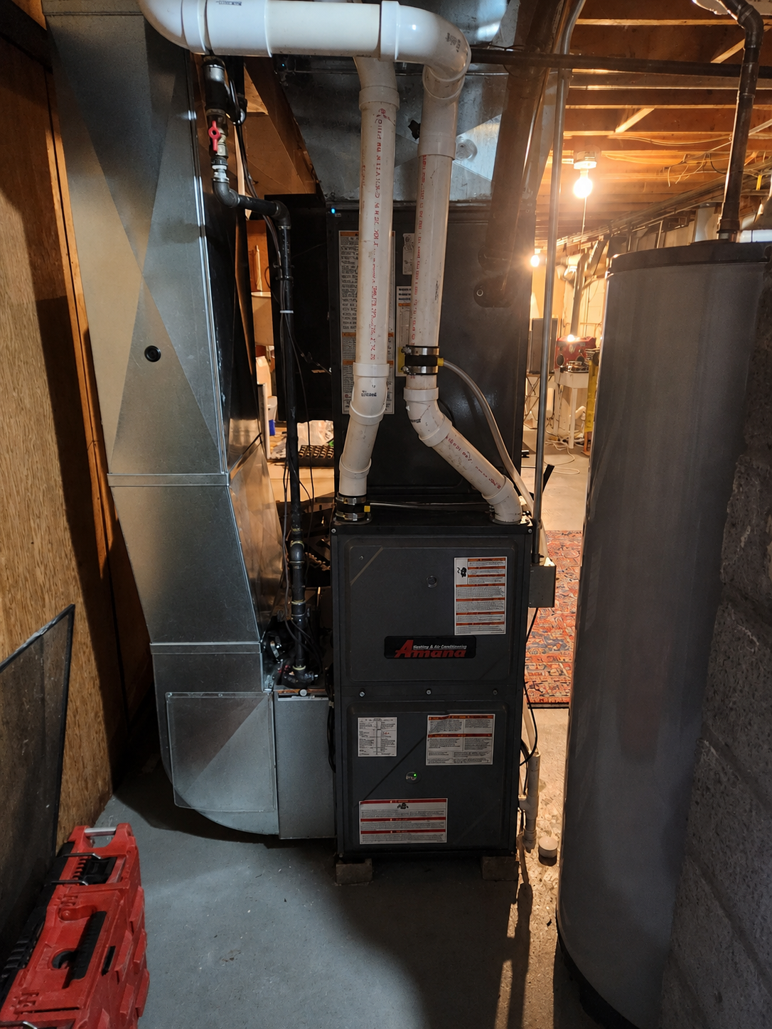 An HVAC furnace unit with vinyl ducts in a basement.