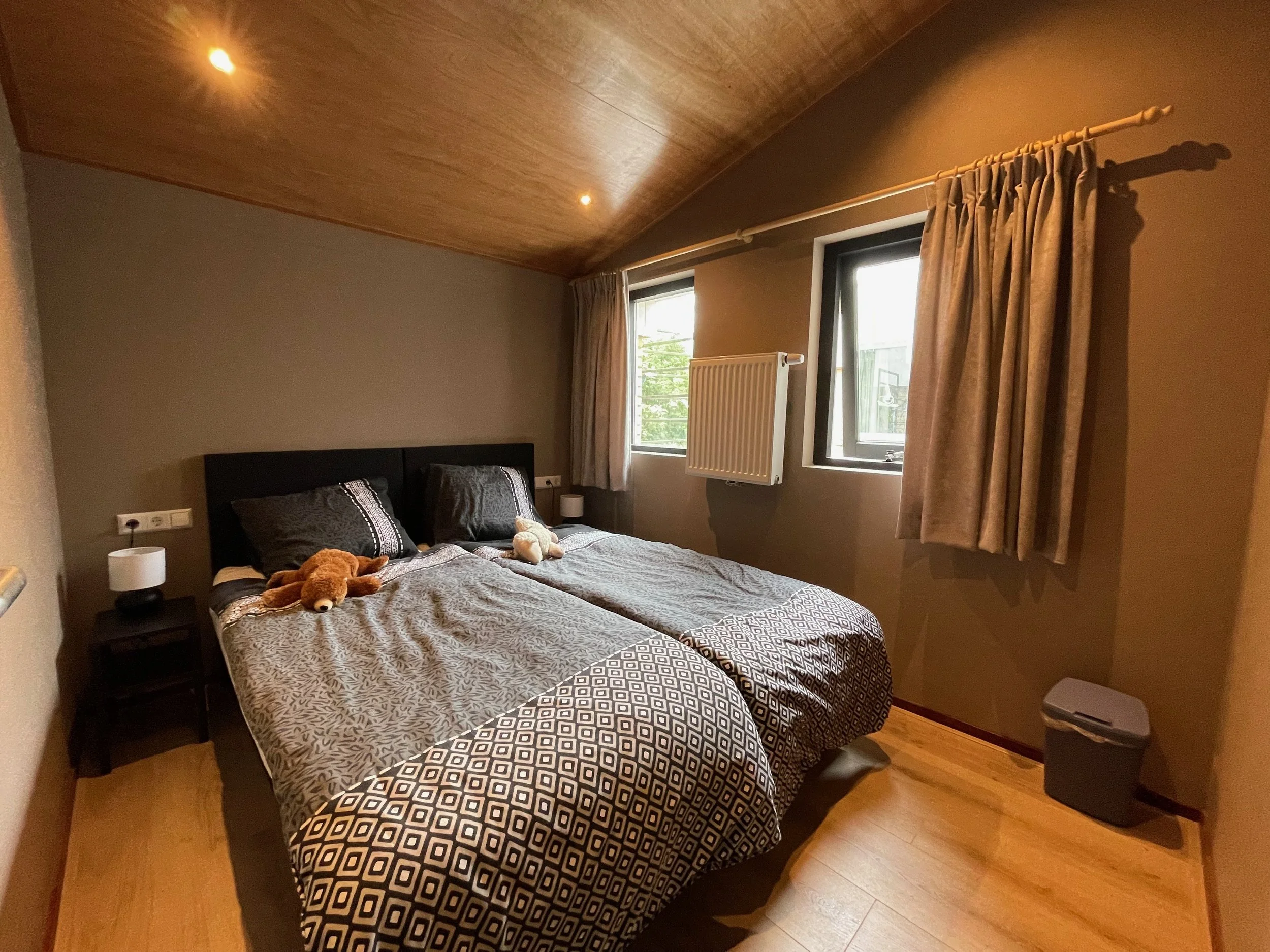 Slaapkamer met tweepersoonsbed en houten plafond in Bungalow Luitekamp in Ballum op Ameland