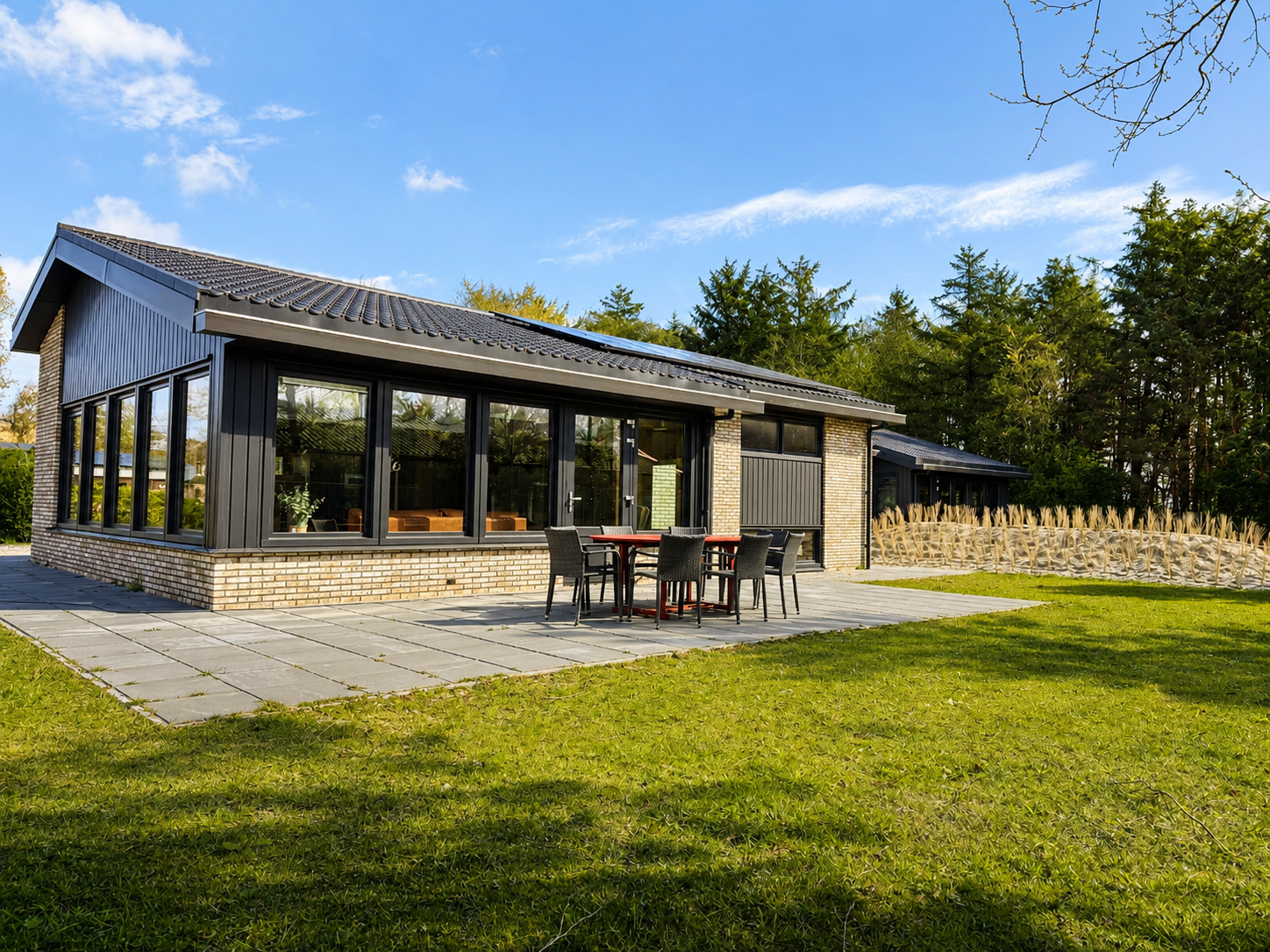 Terras met eettafel aan de achterkant van Villa Duikenburg aan de bosrand in Ballum op Ameland