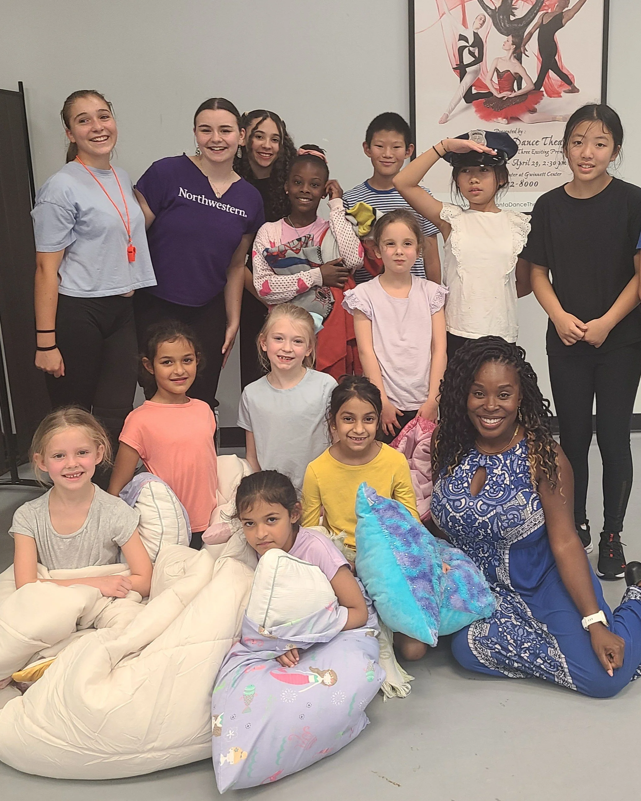 Genesis Beasley with students after a summer camp performance.
