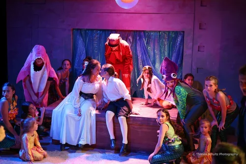 Children in colorful costumes performing on stage in Citadel's Youth Showcase of The Little Mermaid.