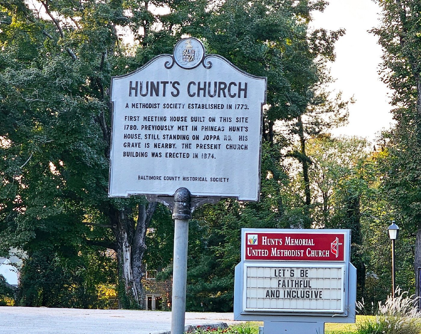Historical marker about Hunt's Church, a Methodist society established in 1773, with a sign from Hunt's Memorial United Methodist Church nearby.
